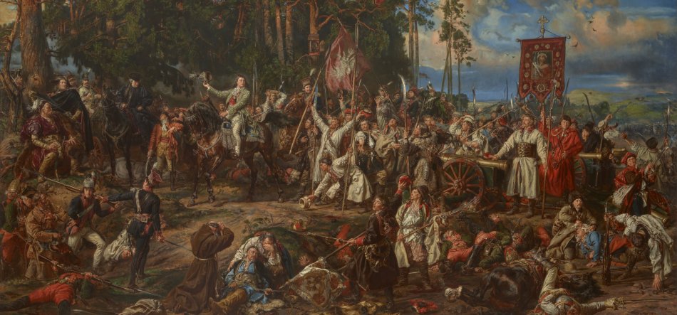 Obraz przedstawia rozległą scenę batalistyczną między sosnami: tłum żołnierzy w historycznych strojach z bronią drzewcową i szablami, konni dowódcy, wóz z chorągwią, widoczne duże sztandary (jeden z białym orłem) oraz liczne ciała i ranni na pierwszym planie pod ciemnym, burzowym niebem.